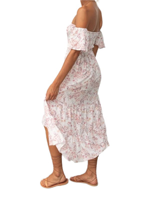 Side view of printed floral midi dress with high low style.