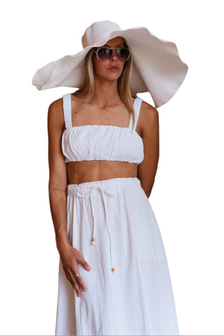 Ruched crop top with thick straps and matching white high waisted skirt.