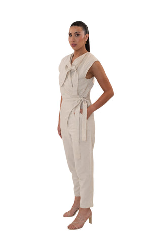 Side view of cross over cream linen jumpsuit with tie waist and top
