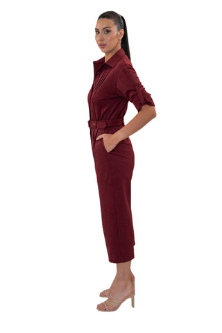 Side view of jumpsuit with tab sleeves and pockets.