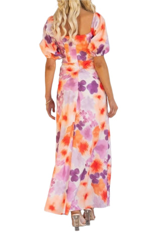 Back view of printed maxi dress with puff short sleeves and zip up back closure.