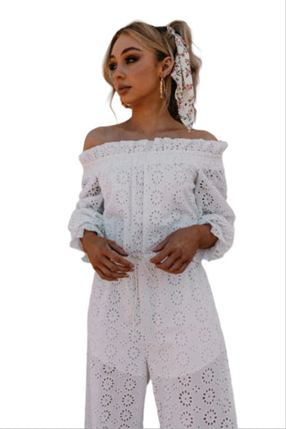 White off the shoulder jumpsuit with tie waist styled with bandana.