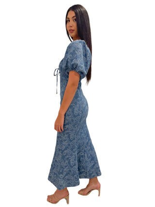 Side view of figgure hugging denim maxi dress with puff sleeves