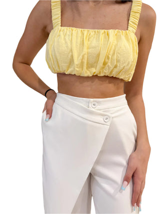 Close up of the cross over detail in the white wide leg pants with pockets.