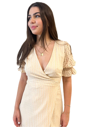 Close up front view of the cross ove dress with contrasting eyelet puff ruffle sleeves.