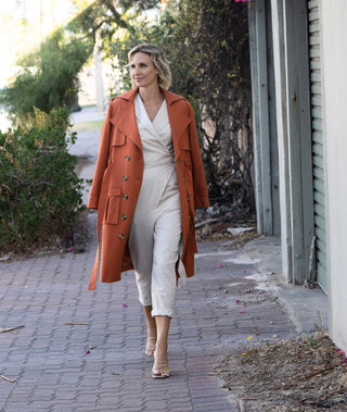 Rebecca Morse wearing our cream linen Coco Jumpsuit street styled with a trench and heels