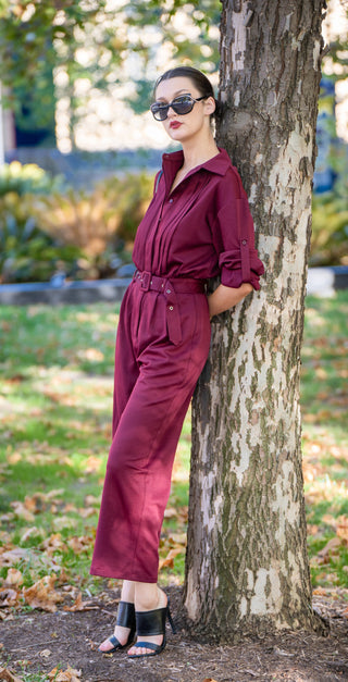 Burgundy pant suit with black sunnies and black heels.