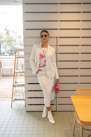 Chic style pinstripe matching skirt and blazer set with printed tee and ankle boots.