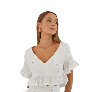 Close up of deep v neckline white crop top.