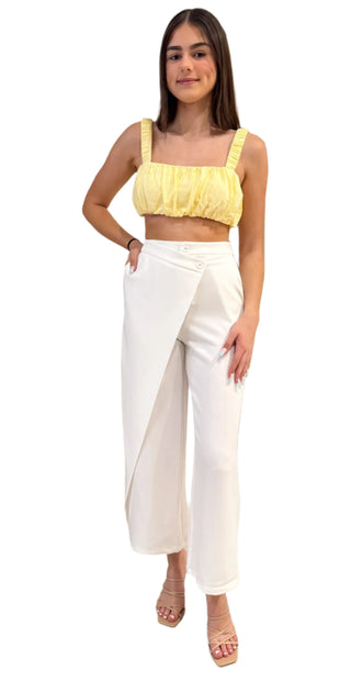 White pant styled with yellow crop and nude heel.