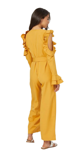 Back view of mustard jumpsuit with ruffles and cut outs, long sleeves and waist tie.