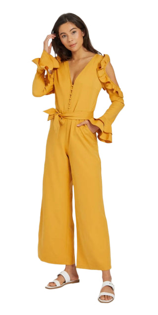 Ruffle jumpsuit in dijon colour with long sleeves and cut out arm, v neckline and waist tie.