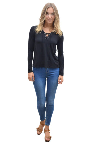 Black tie front top styled with fitted jeans and sandal.