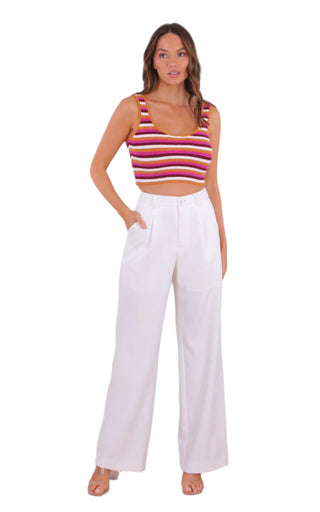 Womens white pants styled with knit multi colour crop top.