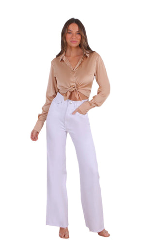 White denim high waisted jeans styled with a brown shirt.