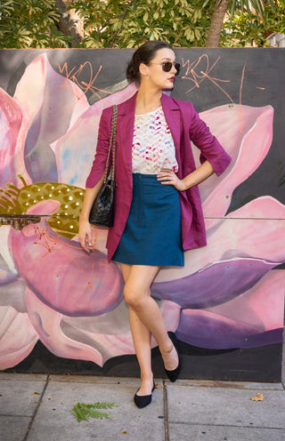 Model styled in sailor blue mini skirt, fuchsia blazer, t shirt and black accessories.