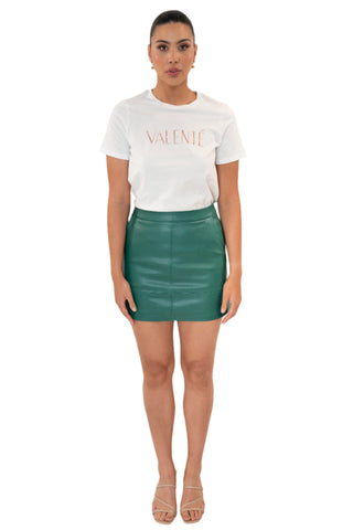 Fitted green pleather mini skirt styled with a logo tee.