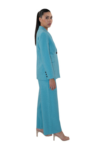 Side view of matching blazer and pant suit in blue pinstripe with black button detail.