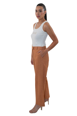 Side view of caramel high waisted pants with side pockets.
