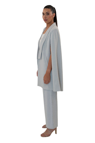Side view of grey flowing cape with side pockets.