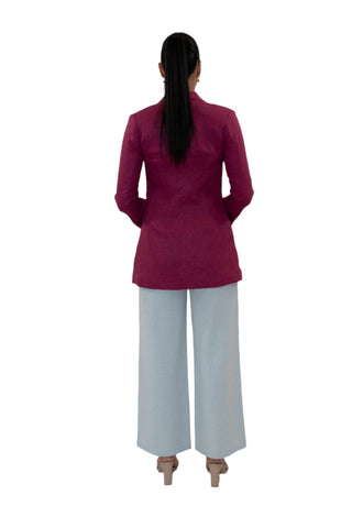 Back view of linen fuchsia blazer with grey pants.