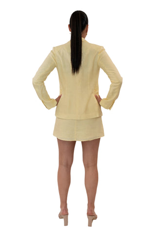 Back view of yellow linen blazer with split sleeves.