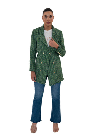 Green tweed coat worn over t shirt and blue jeans.