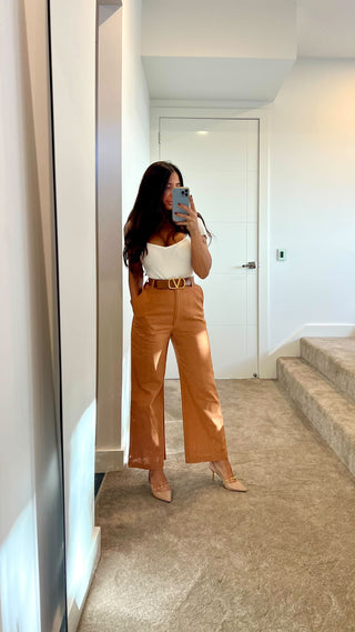 Dr Luve Brigitte Zonta wearing our brown linen Venezia Pant with Versaci belt and heels