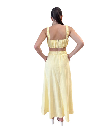 Back view of yellow ruched crop top with matching yellow skirt.