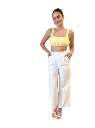 Yellow crop top styled with white high waisted pant.