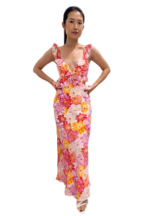 Bright floral printed maxi dress with ruffle detail on shoulders, bust and waist with cut out sides.