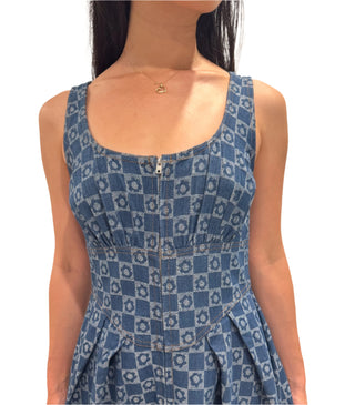 Close up of denim floral print midi dress with zip up front.