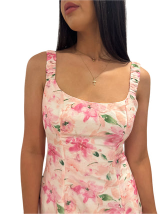 Close up of pink, white and green floral print maxi dress with ruched straps and round neckline