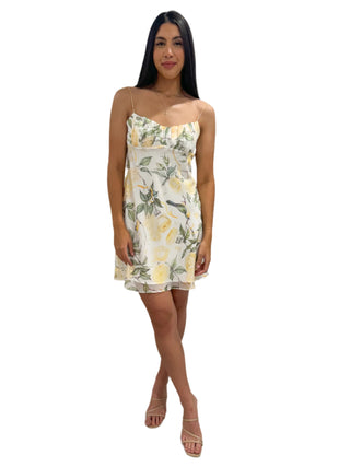 White mini dress with green and yellow floral print, ruched bust and singlet straps