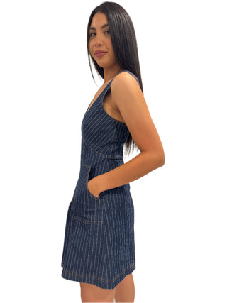 Side view of a-line mini denim dress with side pockets