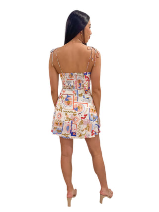 Back view of printed mini dress with eleasticated back panel and tie shoulders
