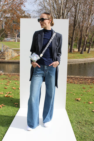 Street style tweed navy coat with navy high neck jumper, denim jeans and cross body bag.