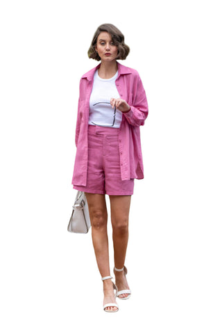 High waisted fuchsia linen shorts style with a white singlet, white bag and white heels.