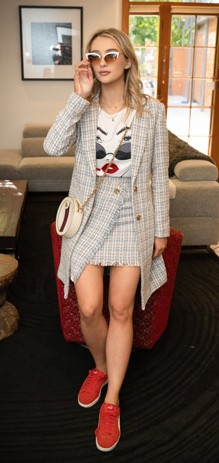 Tweed mini skirt styled with its matching coat, t shirt and sneakers.