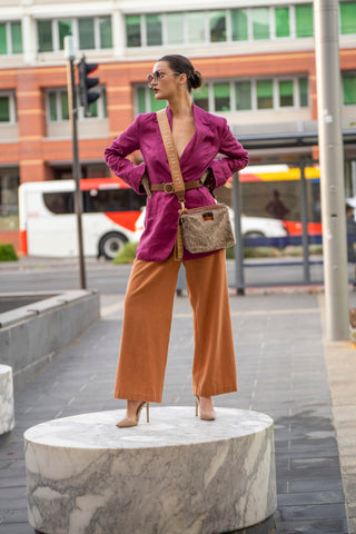 High fashion womens fuchsia blazer styled with brown linen pant.