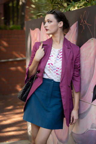 Blue a-line mini skirt with blazer and tee.