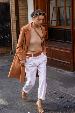 Brown linen jacekt street styled with tank, cross body bag, white jean and heels.