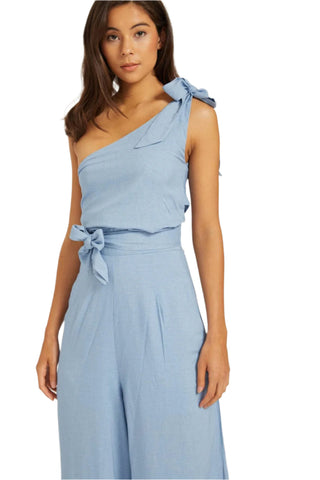 Close up detail of jumpsuit with bow shoulder and bow waist 