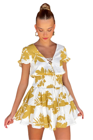 White mini dress with yellow print, short ruffle sleeves, tiered skirt and ruched waist band.