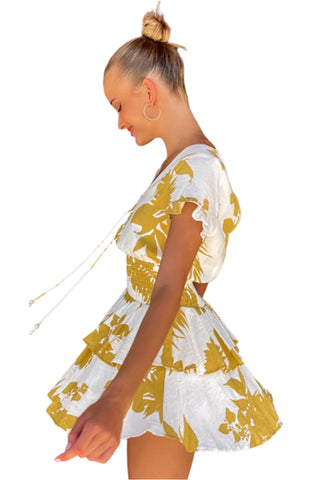 Side view of white and yellow mini dress with full skirt