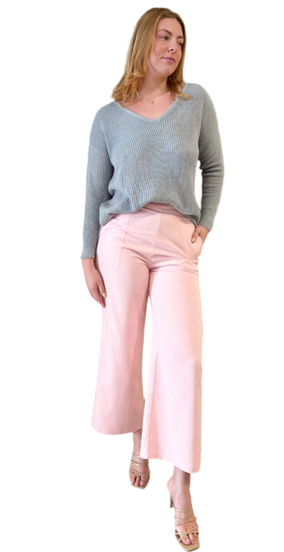 Relaxed style grey ribbed knit with v neckline styled with pink pant.