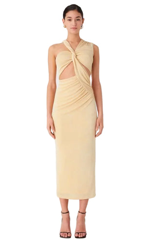 Woman wearing a light yellow dress with cut-out design on a white background