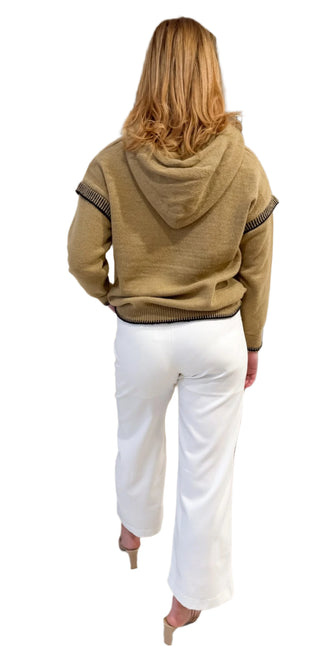 Back view of hooded jumper styled with white pant