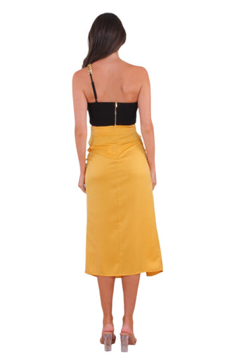 Back view of silky yellow high waisted midi skirt.
